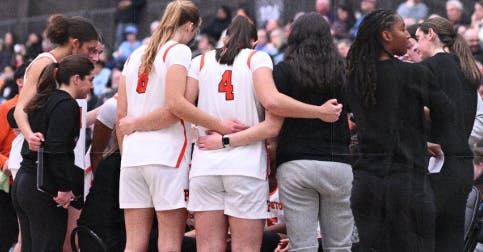 Princeton women's basketball team in a huddle.