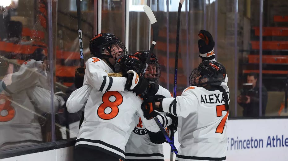 A group of Princeton women’s ice hockey players celebrating a win over Harvard.