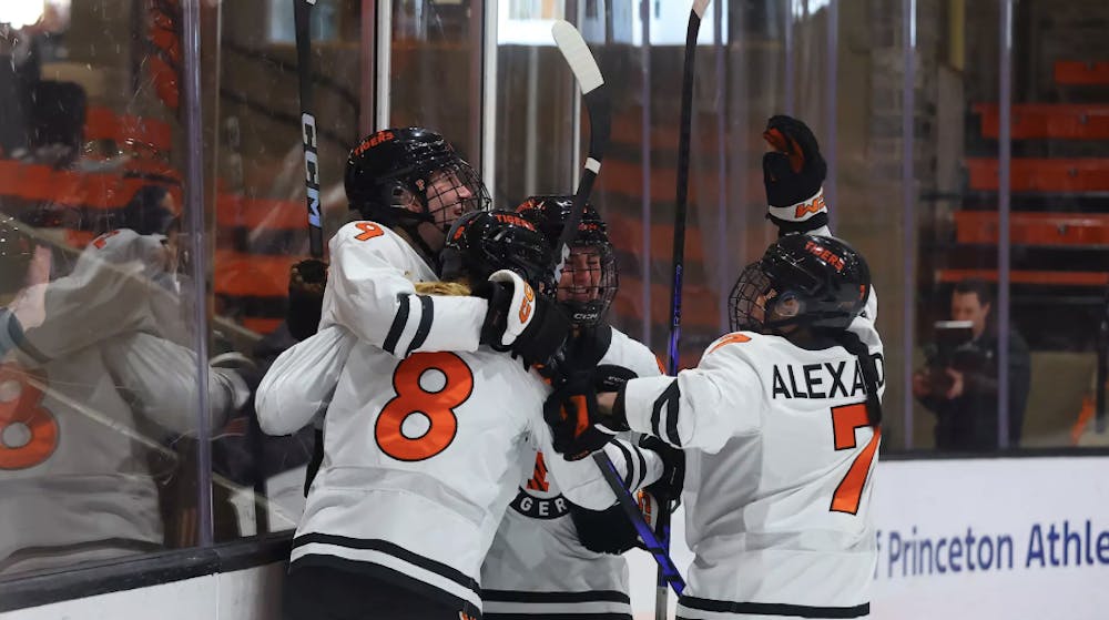 A group of Princeton women’s ice hockey players celebrating a win over Harvard.