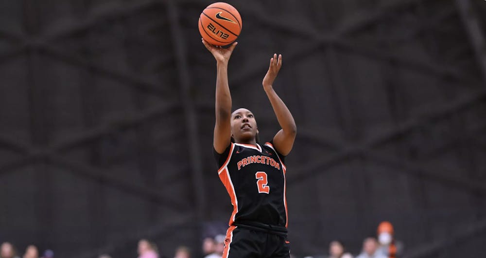 Princeton women's basketball player in orange and black shooting a basketball. 