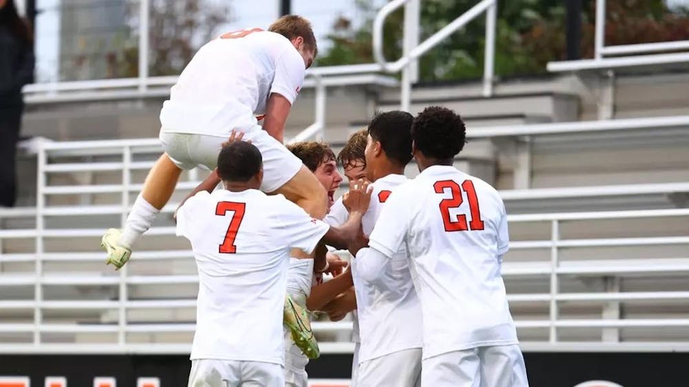 Five men in princeton uniforms celebrate after a goal