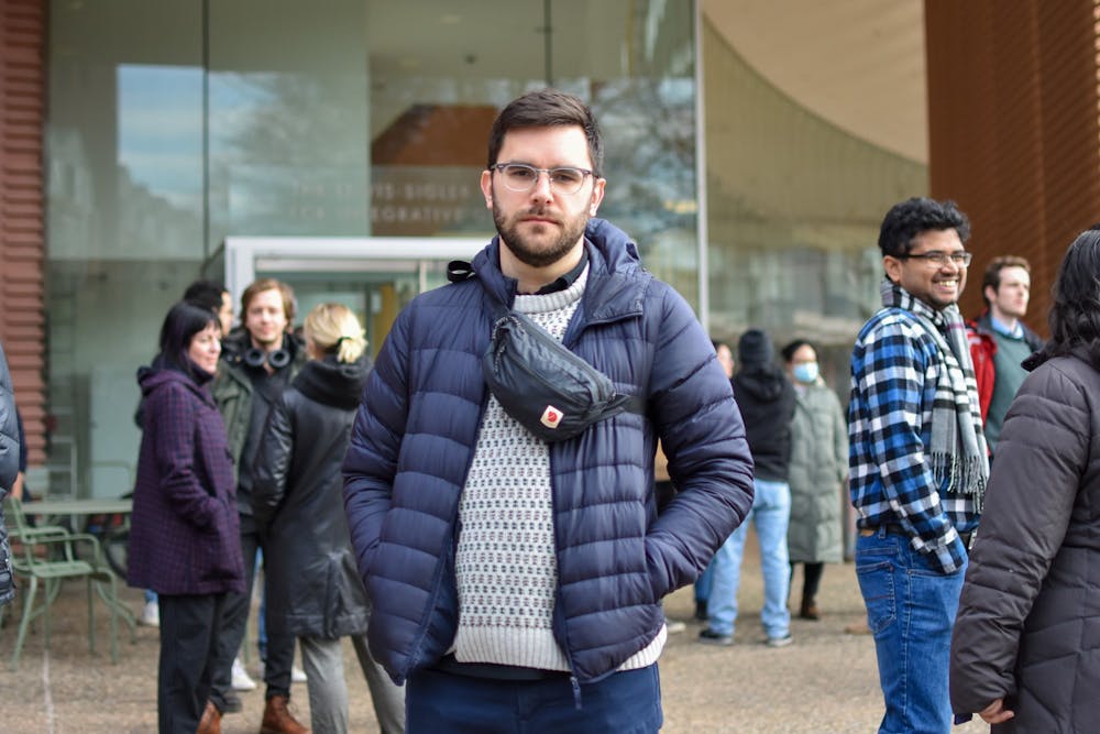 <h5>Harrison Ritz, a postdoctoral researcher and organizer of the demonstration, stands in front of the Icahn building before marching to Nassau Hall.</h5>
<h6>Angel Kuo / The Daily Princetonian</h6>