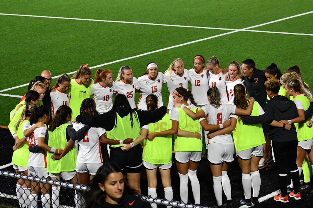 Group of women in white jerseys huddled