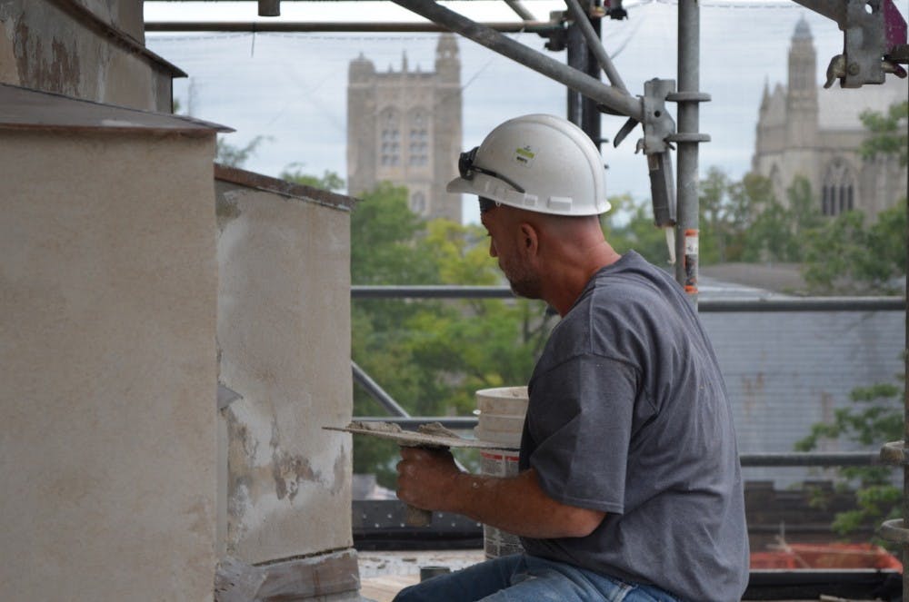 A trade craftsman works on Nassau Hall's renovations. 