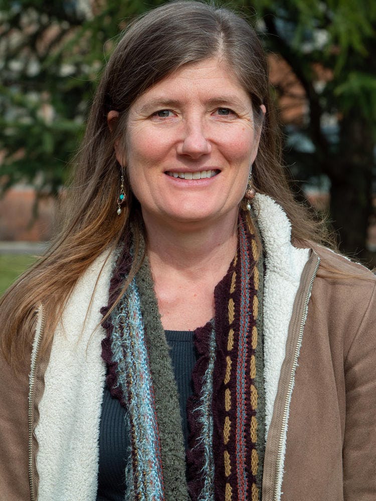 A white woman with long brown hair, smiling.