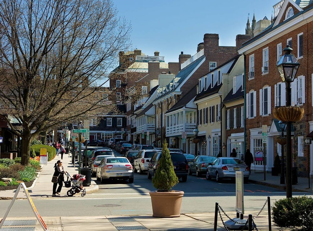 Image of Palmer Square buildings with cars driving down street. 