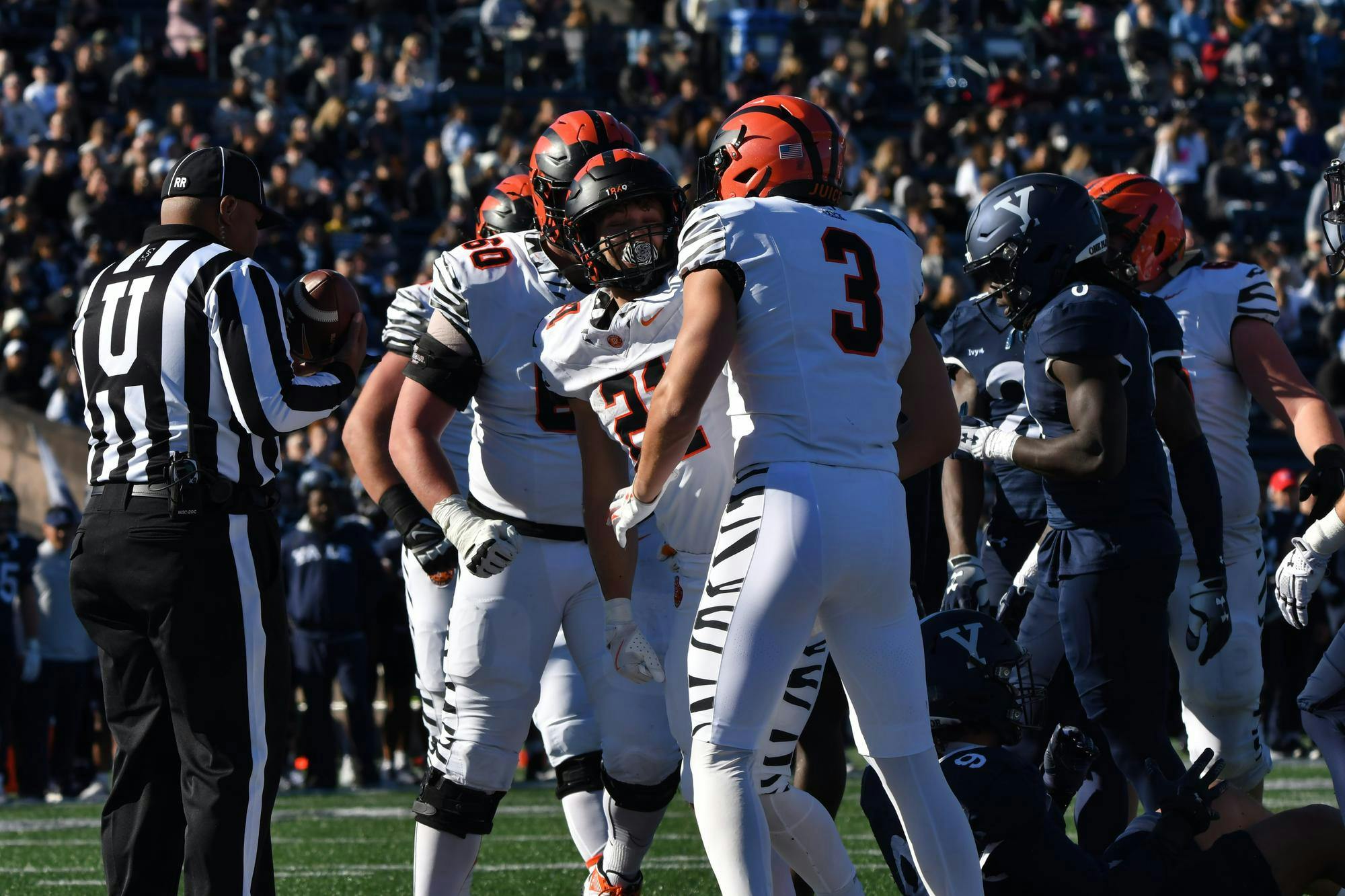 Football players standing in a crowd.