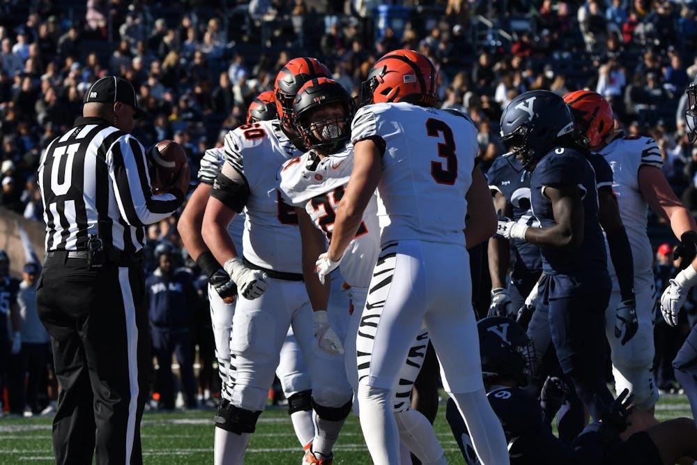 Football players standing in a crowd.