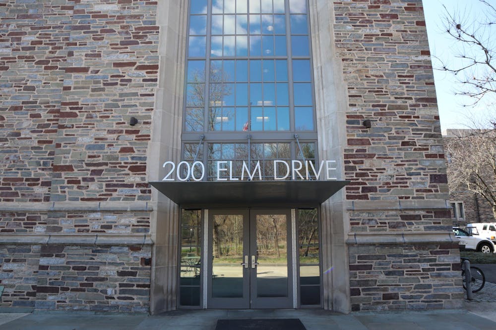 A stone building with large letters above the doorway spelling, “200 Elm Drive”