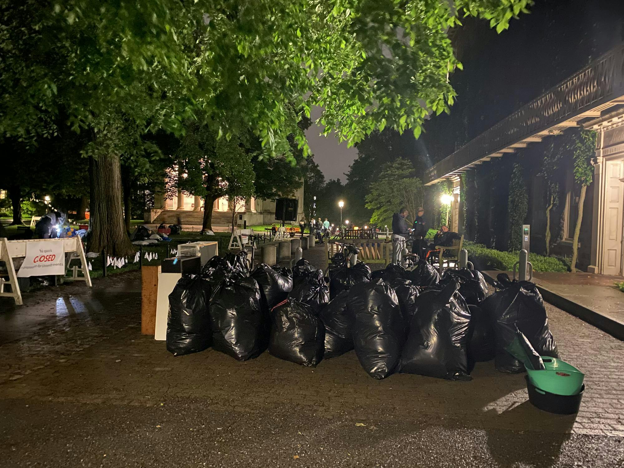 Around twenty black trash bags are between Morrison Hall and Cannon Green.