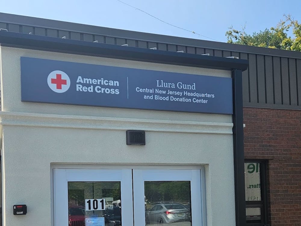 Beige colored building with a sign on top, displaying from left to right: The logo of the American Red Cross, the words American Red Cross, then the words Llura Gund Central New Jersey Headquarters and Blood Donation Center