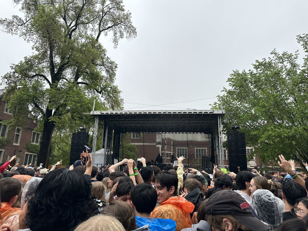 Photo of students partying in the rain in front of the main stage at Lawnparties.