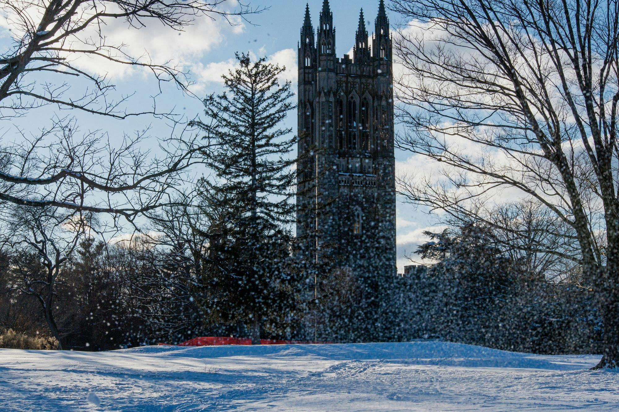 Snow&#x20;falls&#x20;across&#x20;Princeton&#x20;University&#x2019;s&#x20;campus&#x20;as&#x20;the&#x20;Graduate&#x20;College&#x20;tower&#x20;rises&#x20;behind&#x20;trees&#x20;on&#x20;a&#x20;winter&#x20;afternoon.