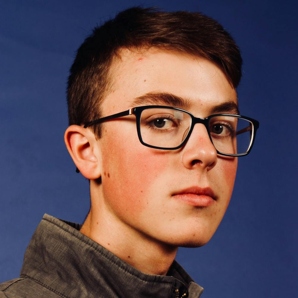Photo of boy with glasses on a dark blue background