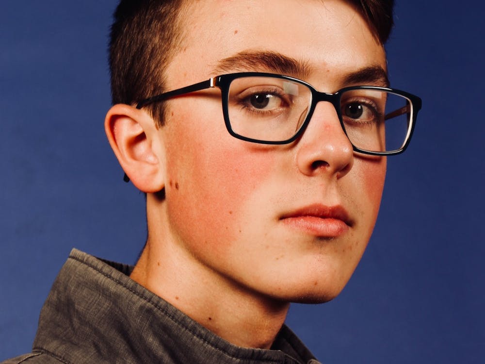 Photo of boy with glasses on a dark blue background