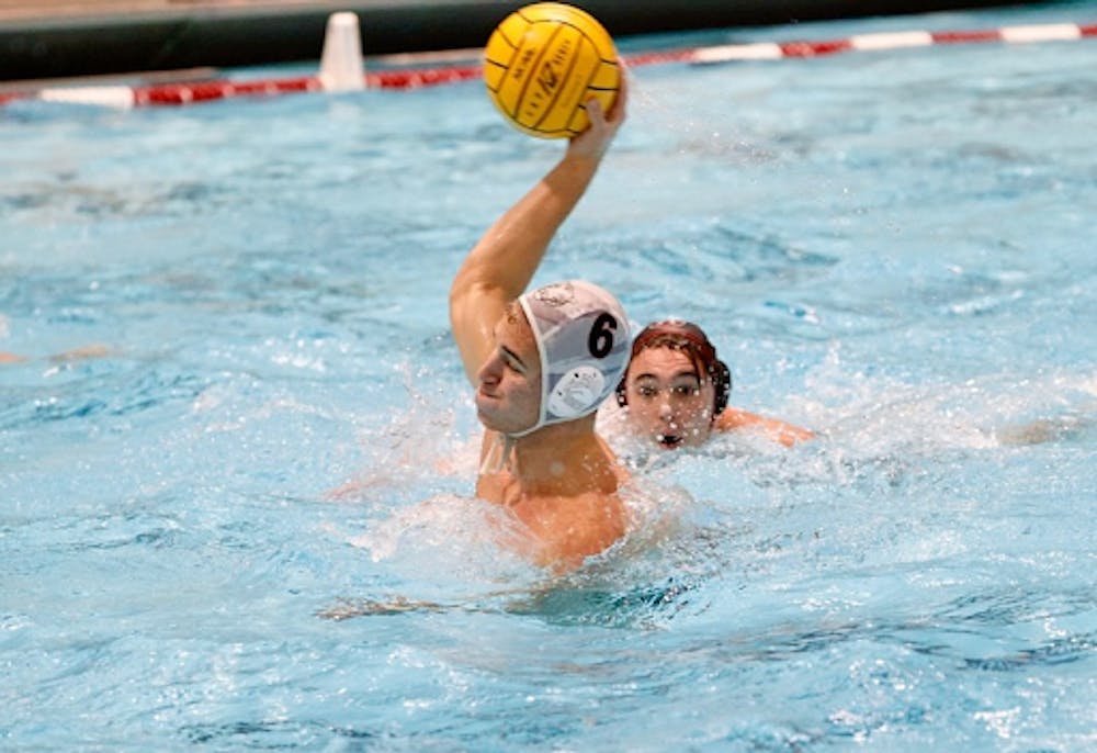 man in water polo headgear gathers up to shoot 