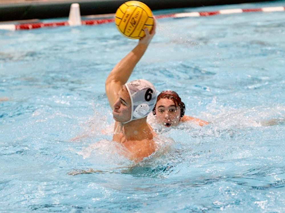 man in water polo headgear gathers up to shoot