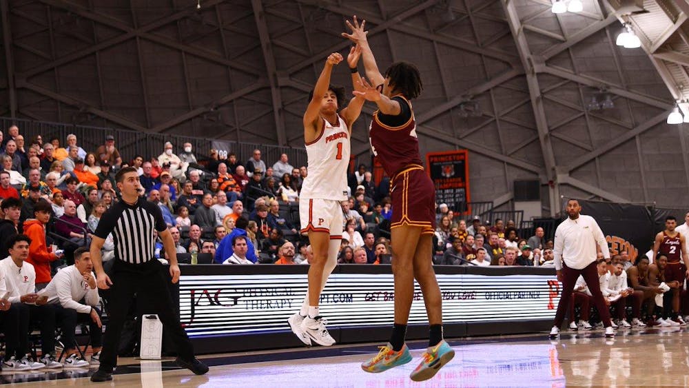 Basketball player jumping for shot over another player.