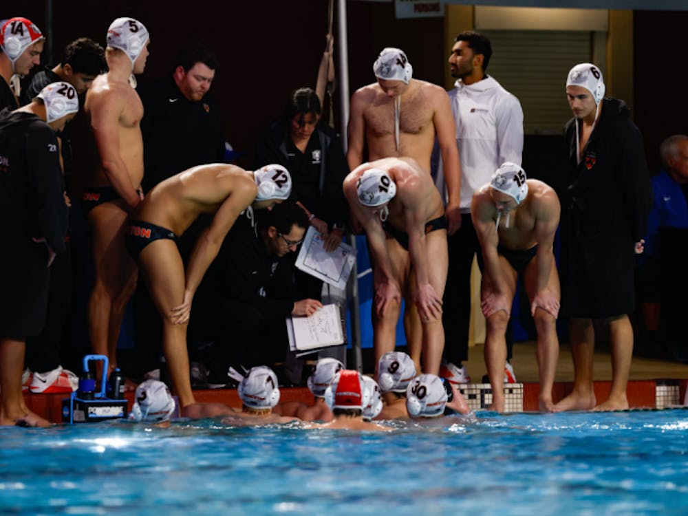 A group of men in a huddle looking at a man giving them directions on a piece of paper.