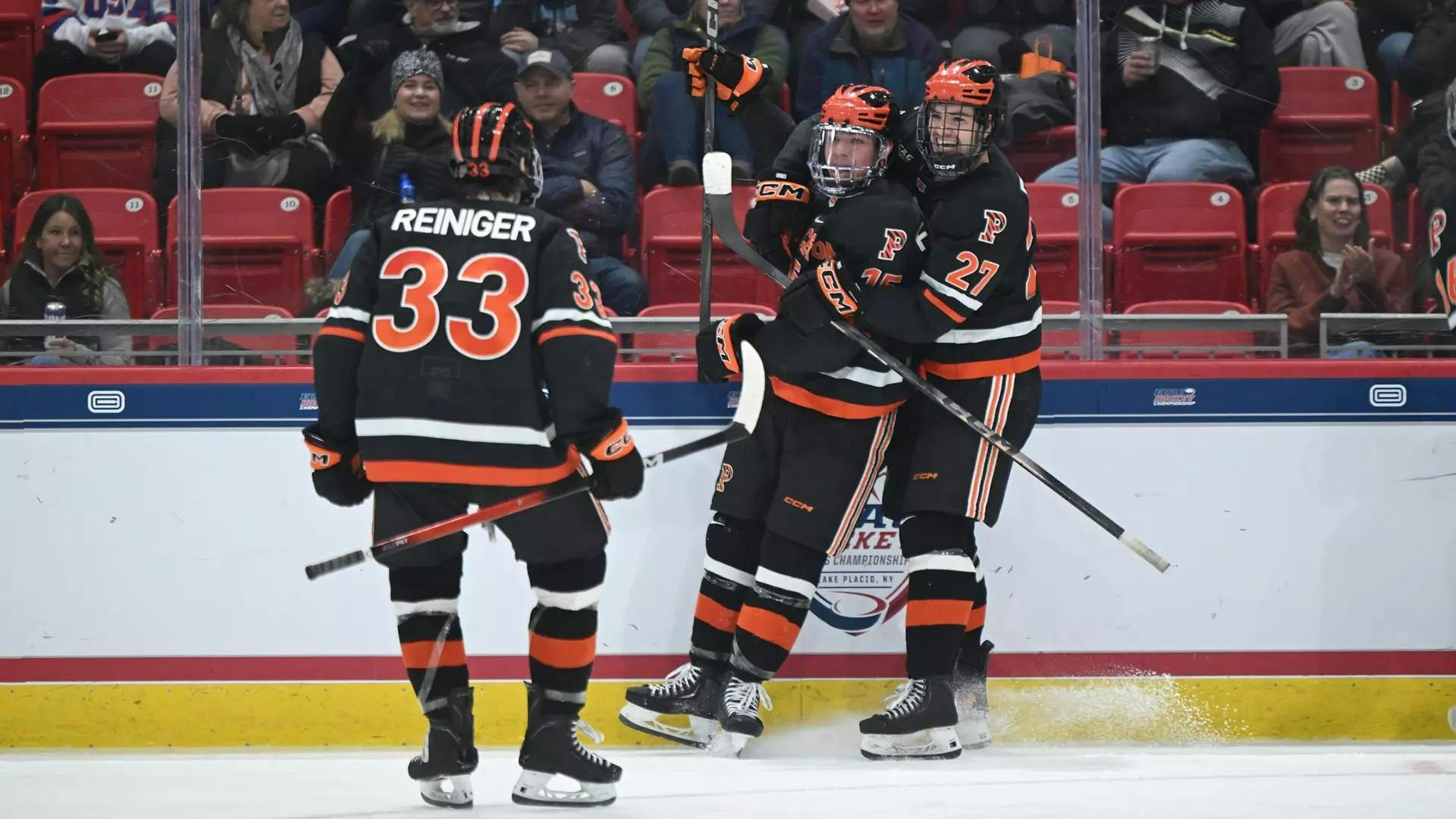 Hockey players hug on ice.