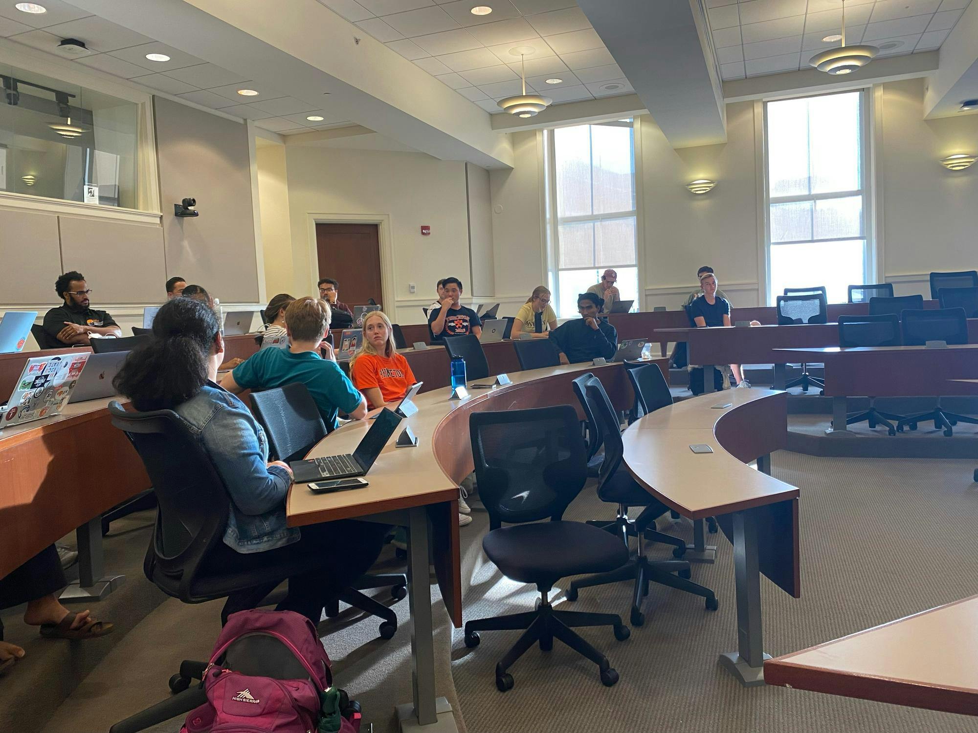 Student government members sitting in meeting room.