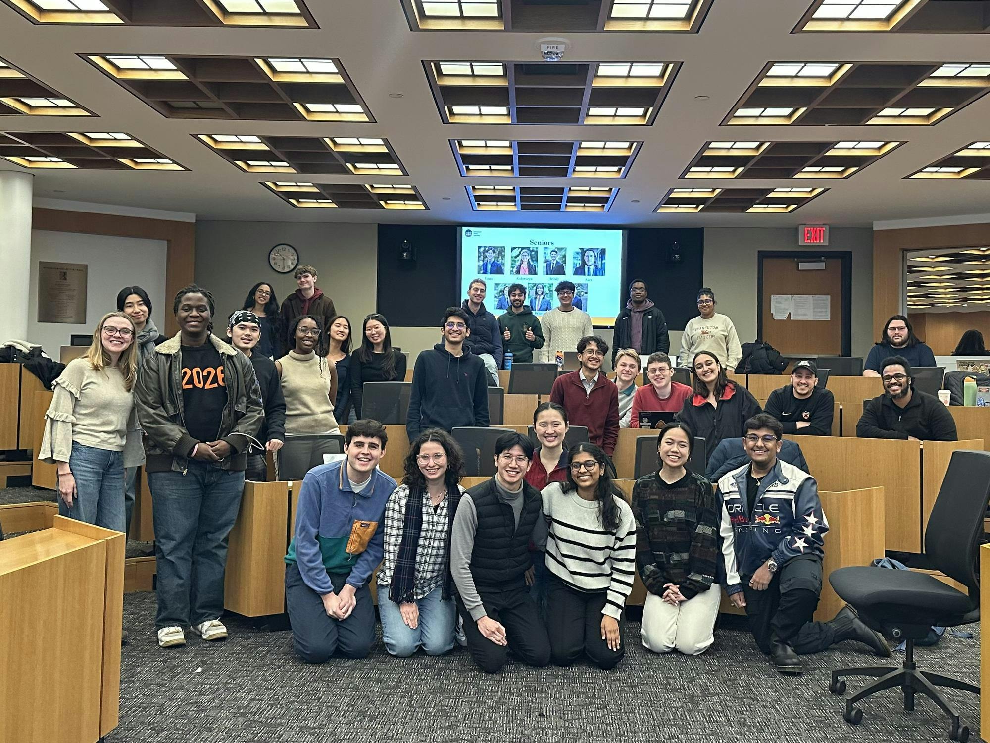The members of the 2025 Undergraduate Student Government standing happily around in Robertson Hall following their last meeting of the semester.