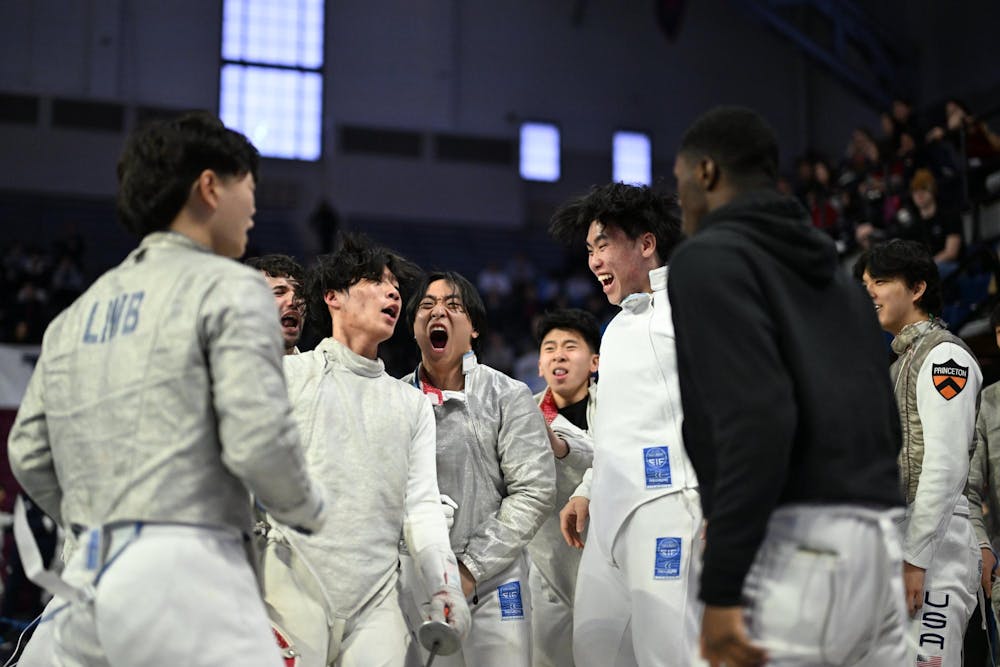 Men in fencing suits celebrate 