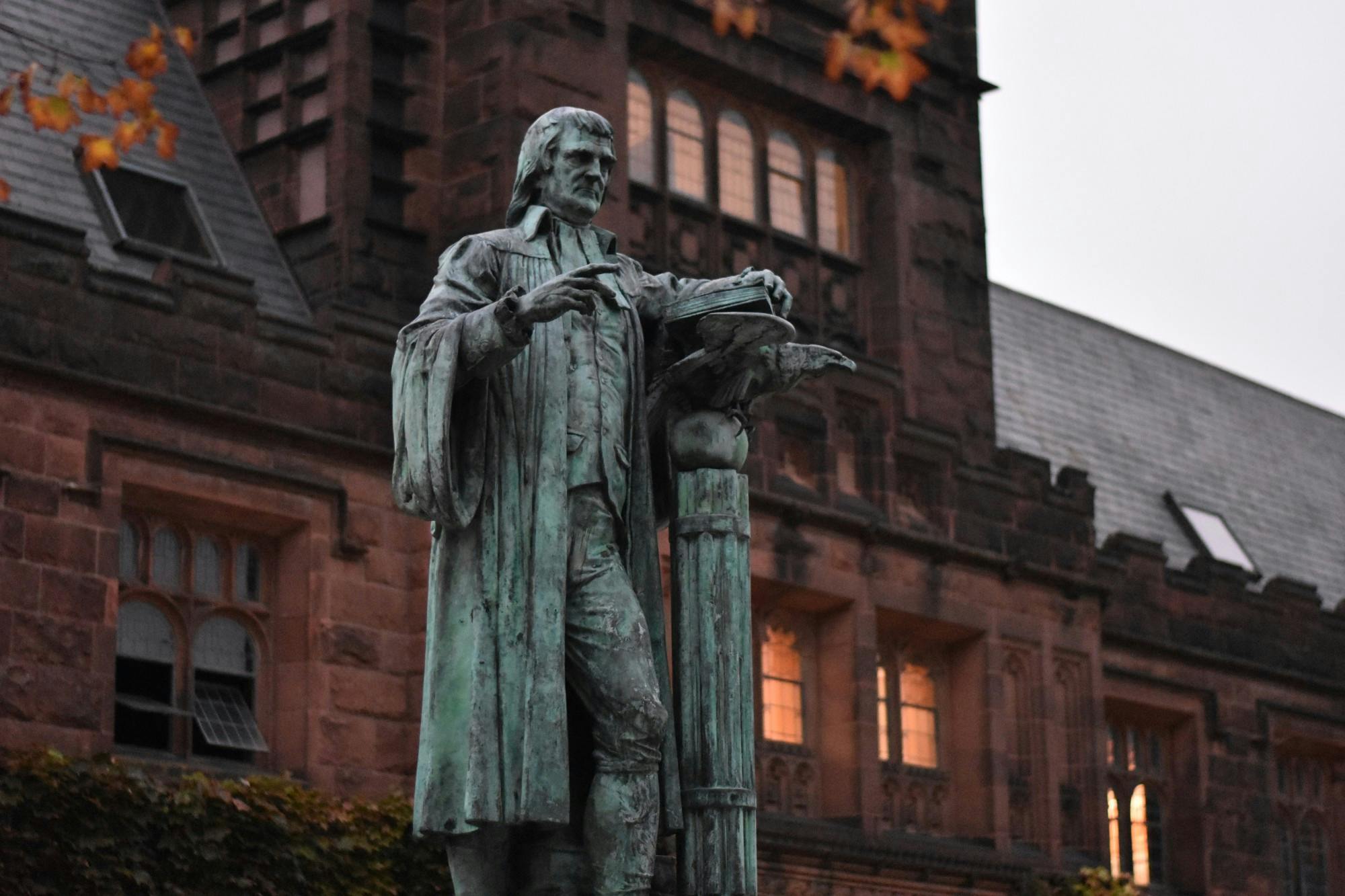 Old statue in front of building.