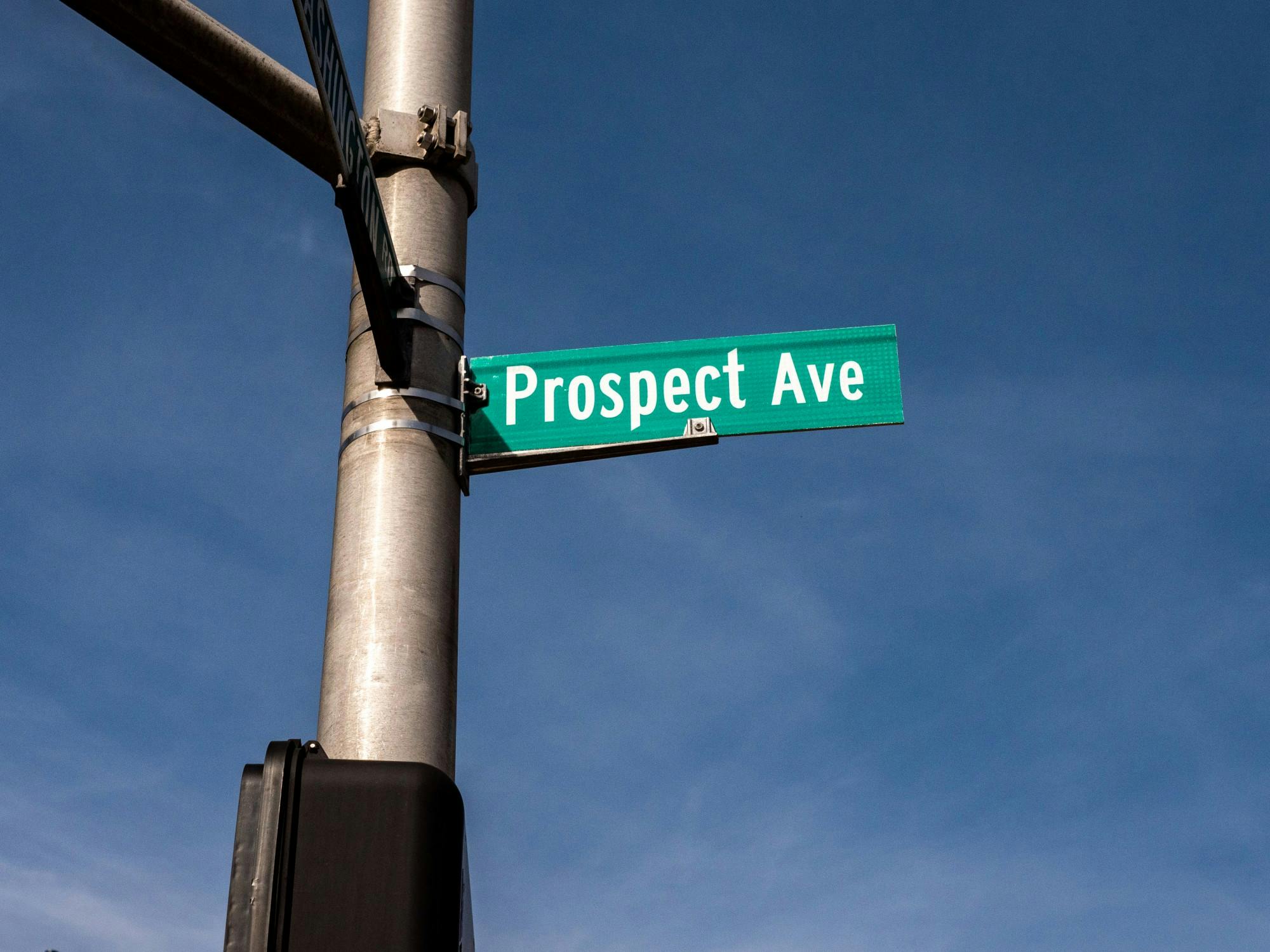A pole with a street sign that says “Prospect Ave.”
