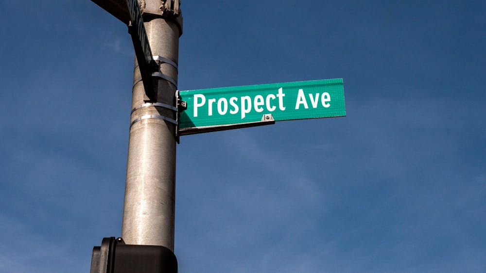 A pole with a street sign that says “Prospect Ave.”