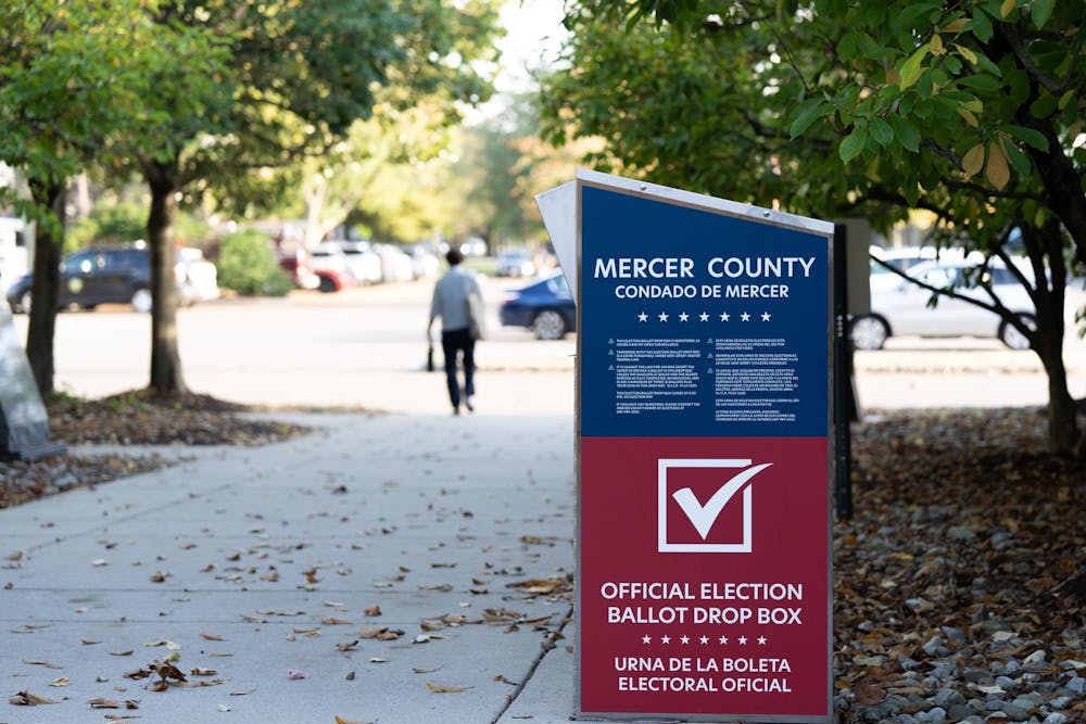 A blue and red metal drop box. The text on the side reads: “Mercer County official election ballot drop box.”