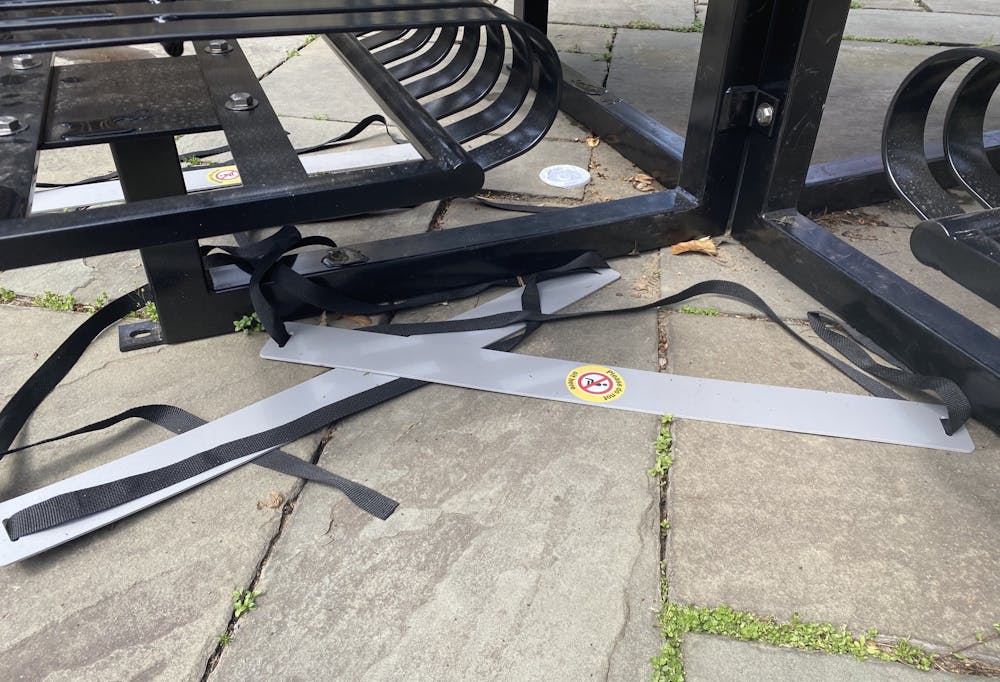 <h5>Straps used for social distancing discarded beneath seats near Wu Hall.</h5>
<h6>Justin Cai / The Daily Princetonian</h6>