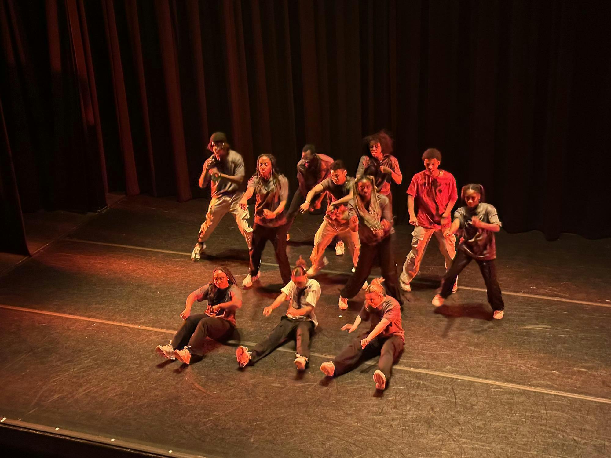 The Frist Theater in orange lighting, members of BAC dance their Halloween-themed choreography: "Dancing Dead."