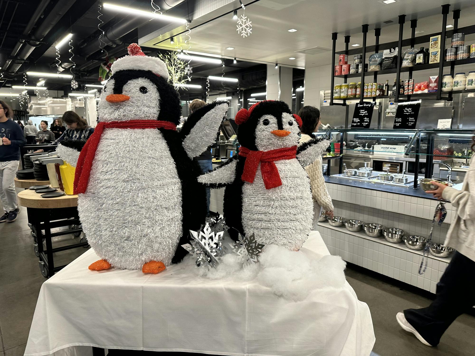 Two holiday penguin decorations on a table in the Choi Dining Hall.
