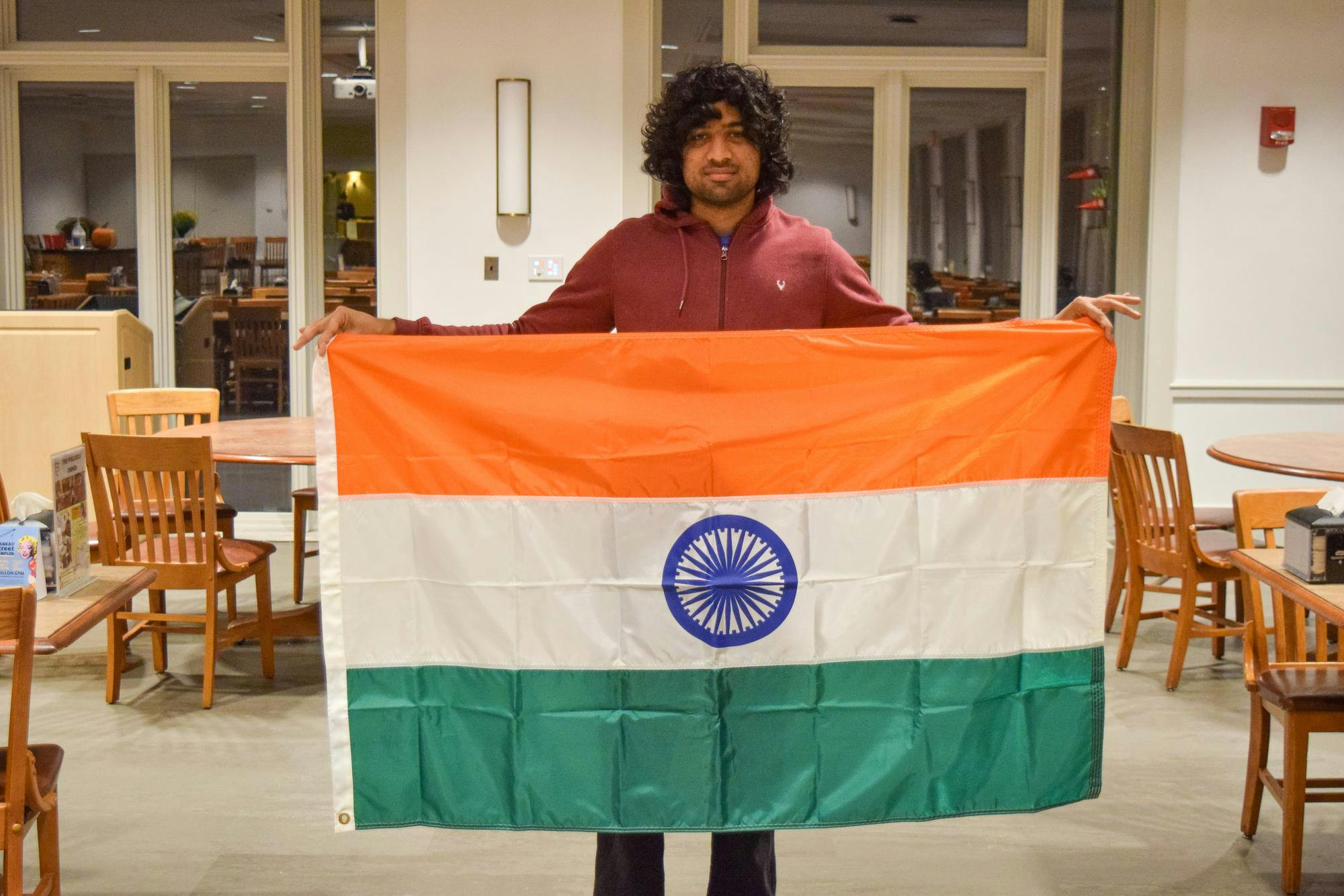 Student in the center holds the flag of India.