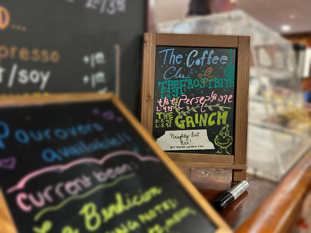 A small chalkboard displaying, in colorful lettering, the items of the seasonal holiday menu. 