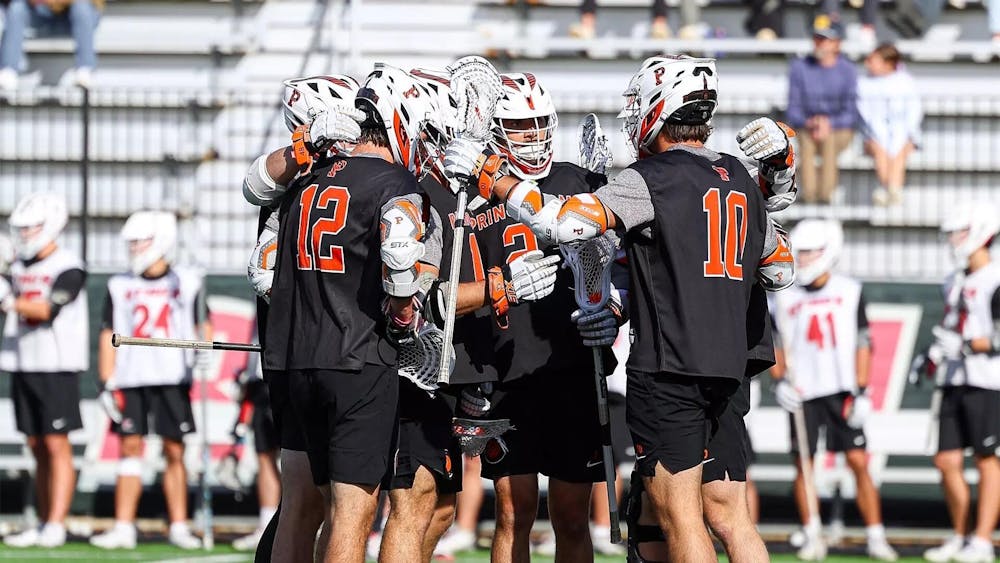 Group of Princeton Men's Lacrosse players circling up together.