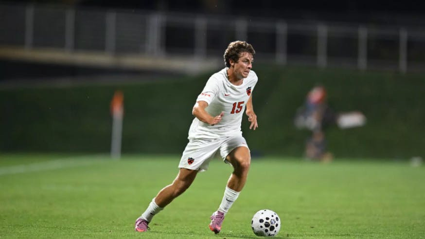 Princeton men's soccer player dribbling the ball.