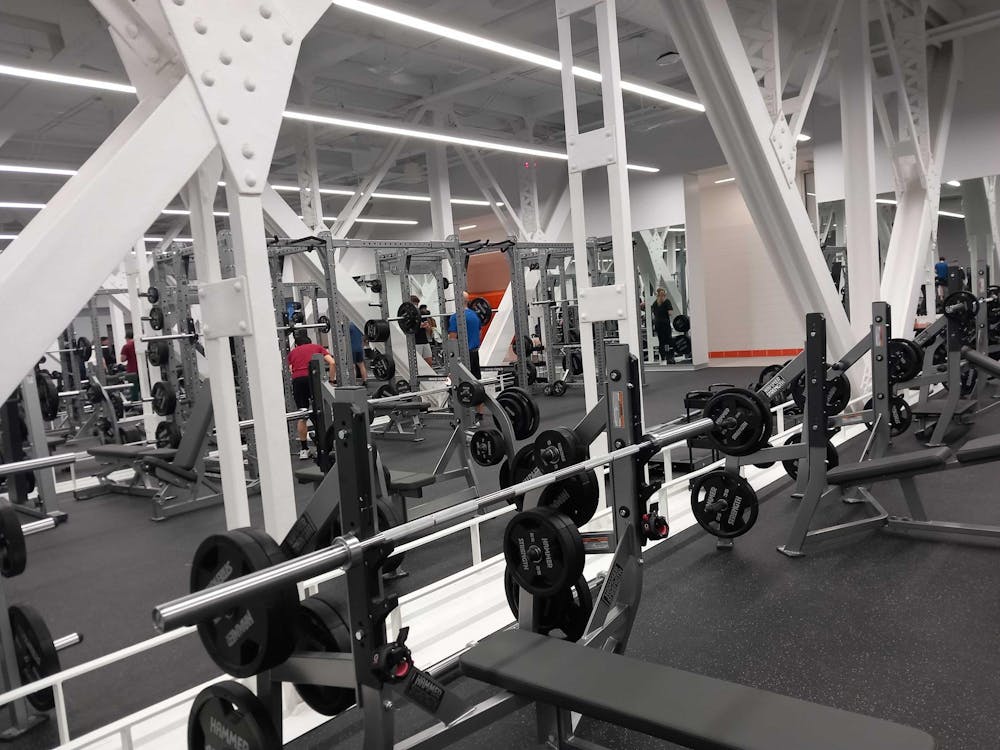 A row of weights lined up in front of a mirror