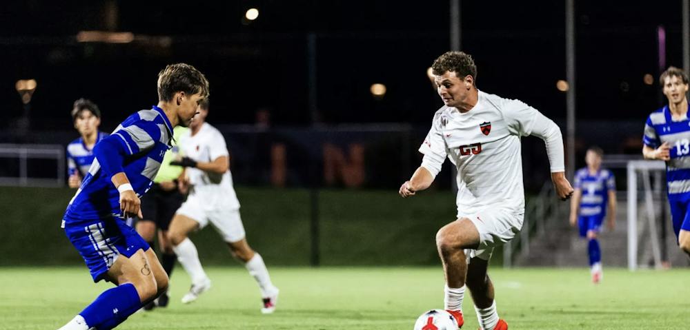 Princeton soccer player against a Dartmouth player.