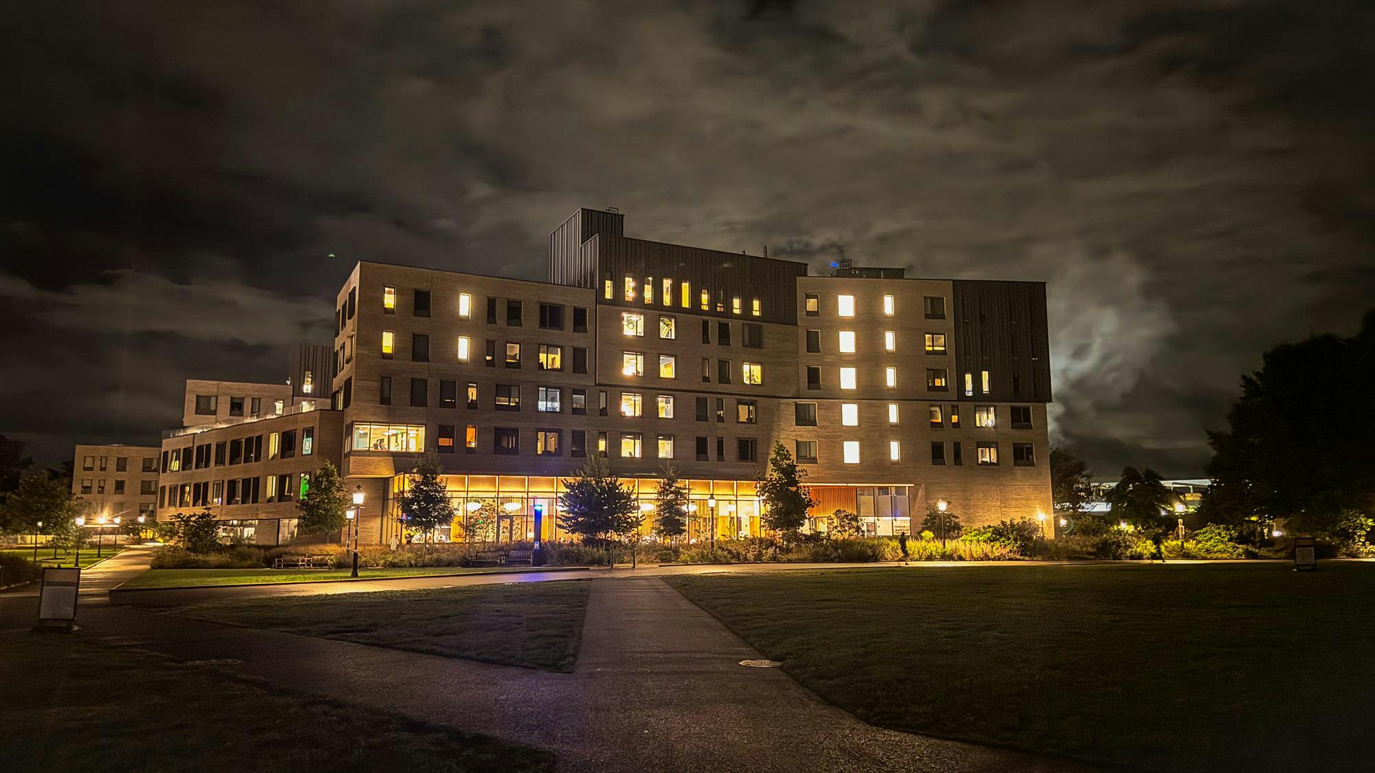 New College West residential college at night, with windows and visible clouds in the sky.
