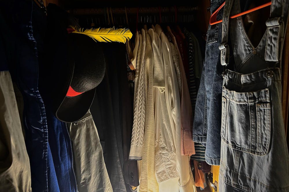 Clothes hanging in a closet. 