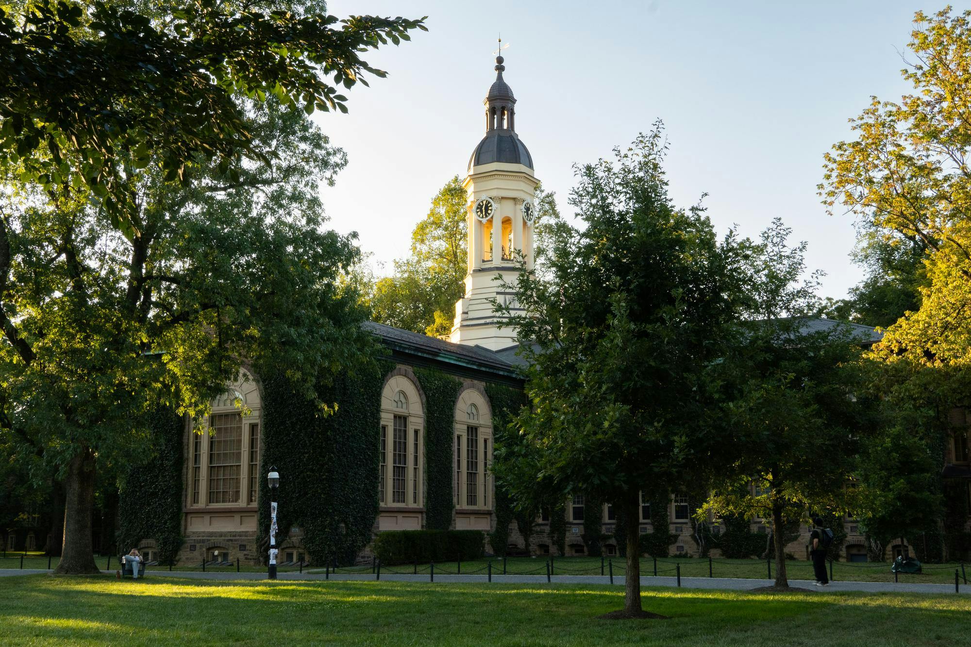 The southfacing side of Nassau Hall, a large building covered in Ivy.
