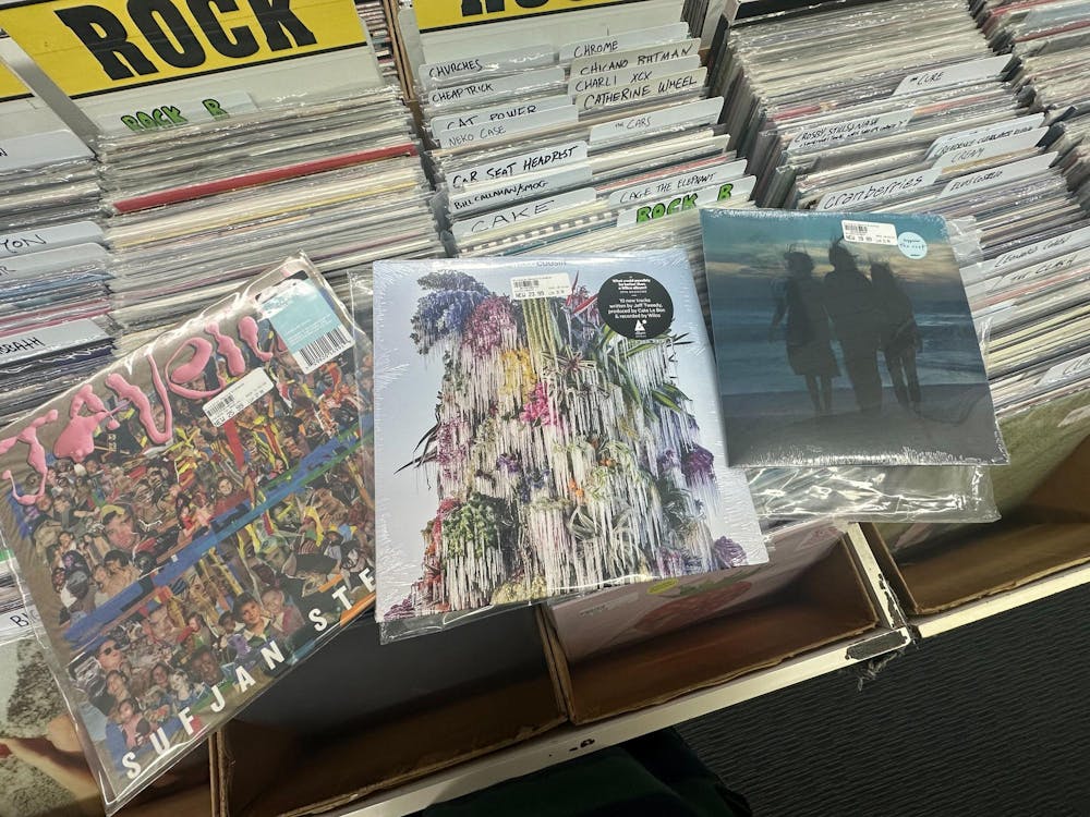 Three records lay on top of several boxes of albums.