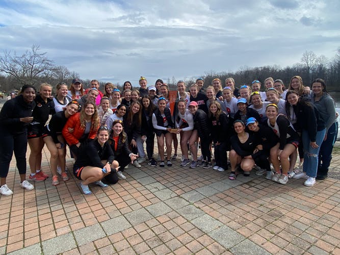 Women's openweight poses with Class of 1987 Trophy