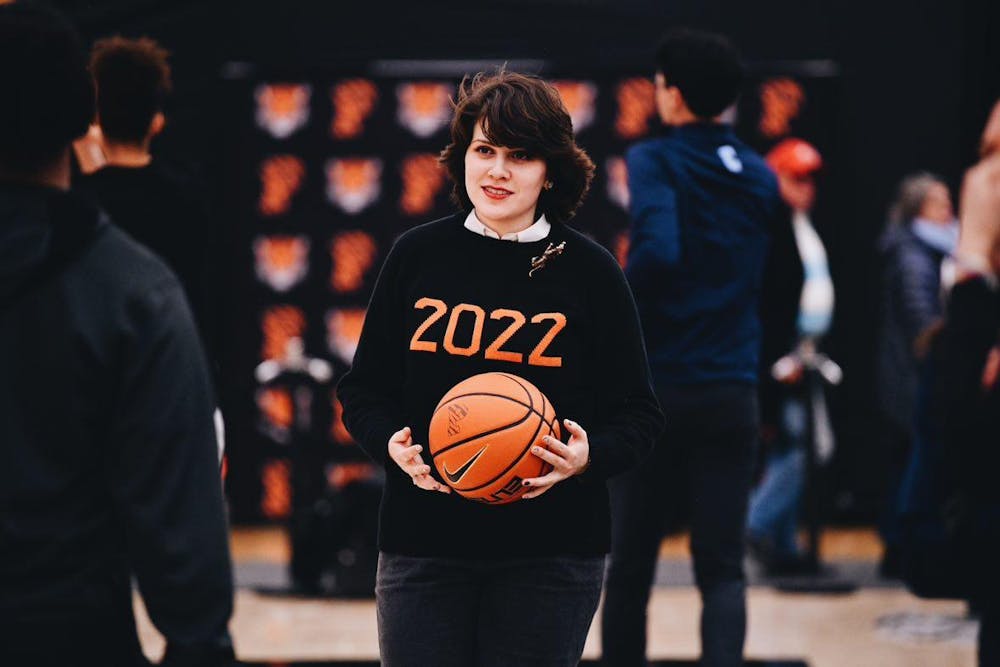 A woman holding a basketball.