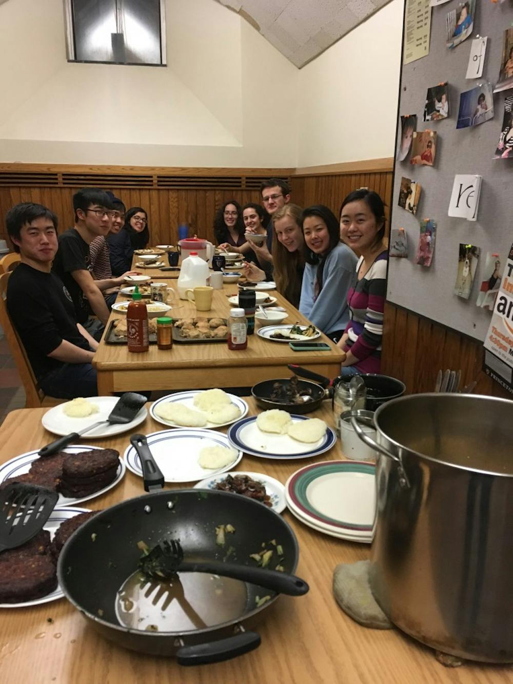 Members of Real Food co-op eating asian-style vegan black bean burgers on Feb. 14.