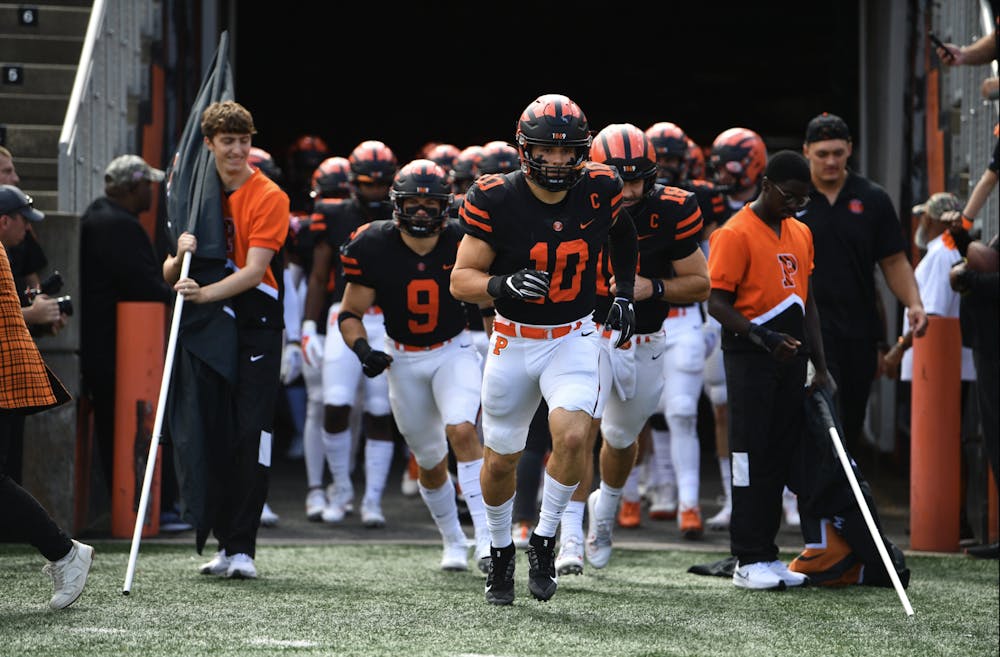 The Princeton Football team runs out of the tunnel for the start of their game against Cornell last Saturday.