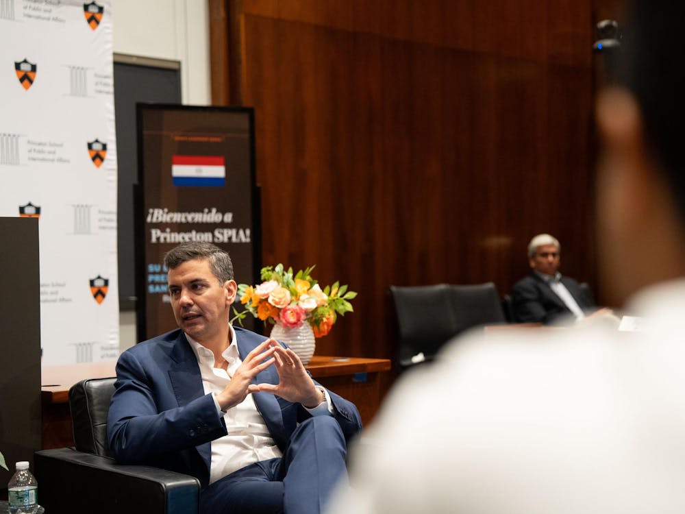 A man in a blue suit sits mid-discussion.