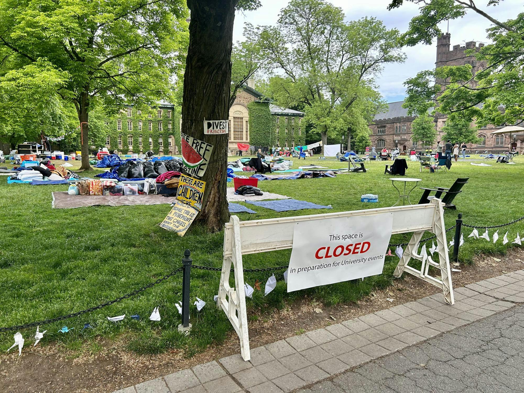 A white barrier with a sign that reads "This space is closed in preparation for University events"